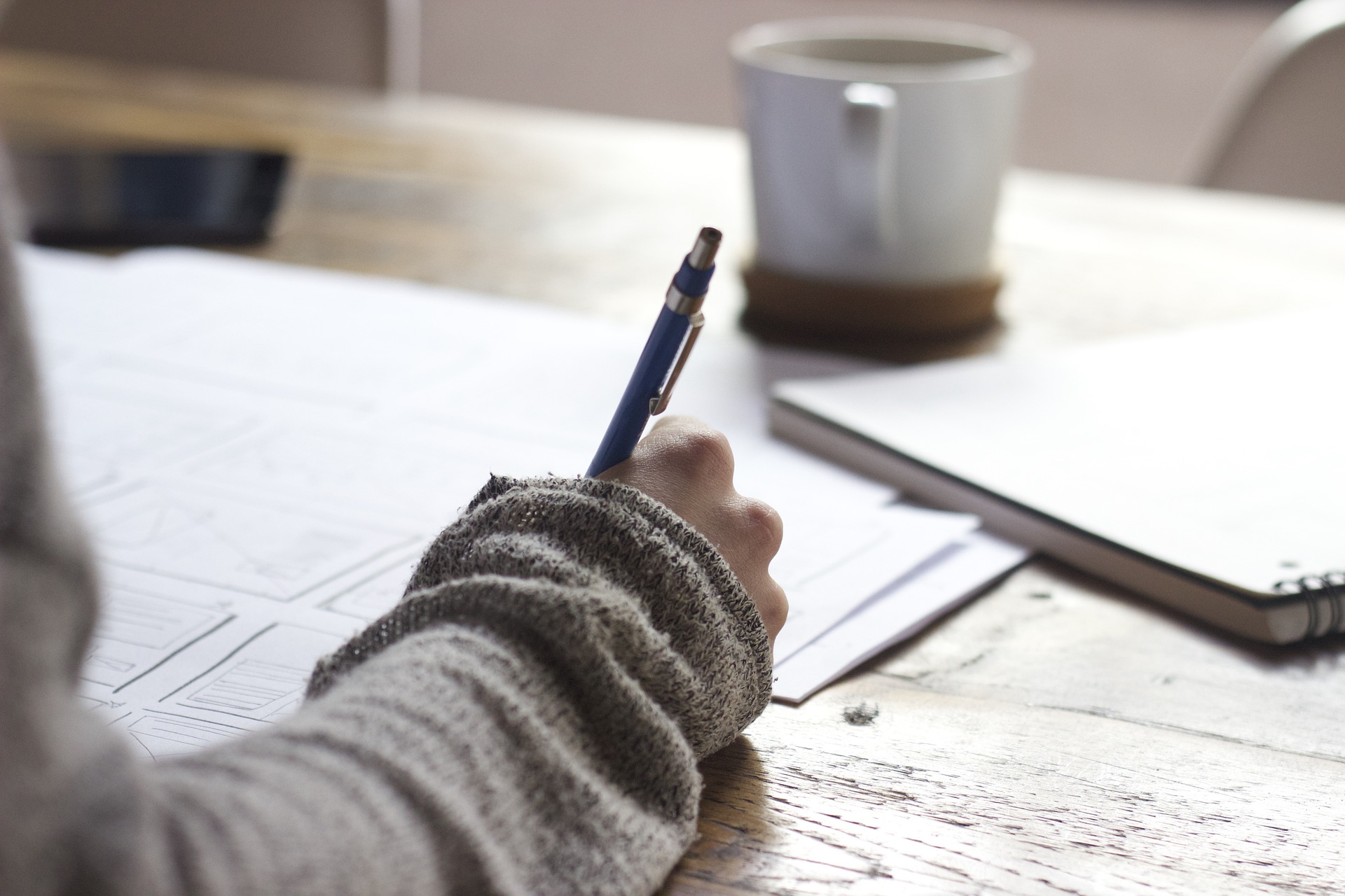 student writing at a desk