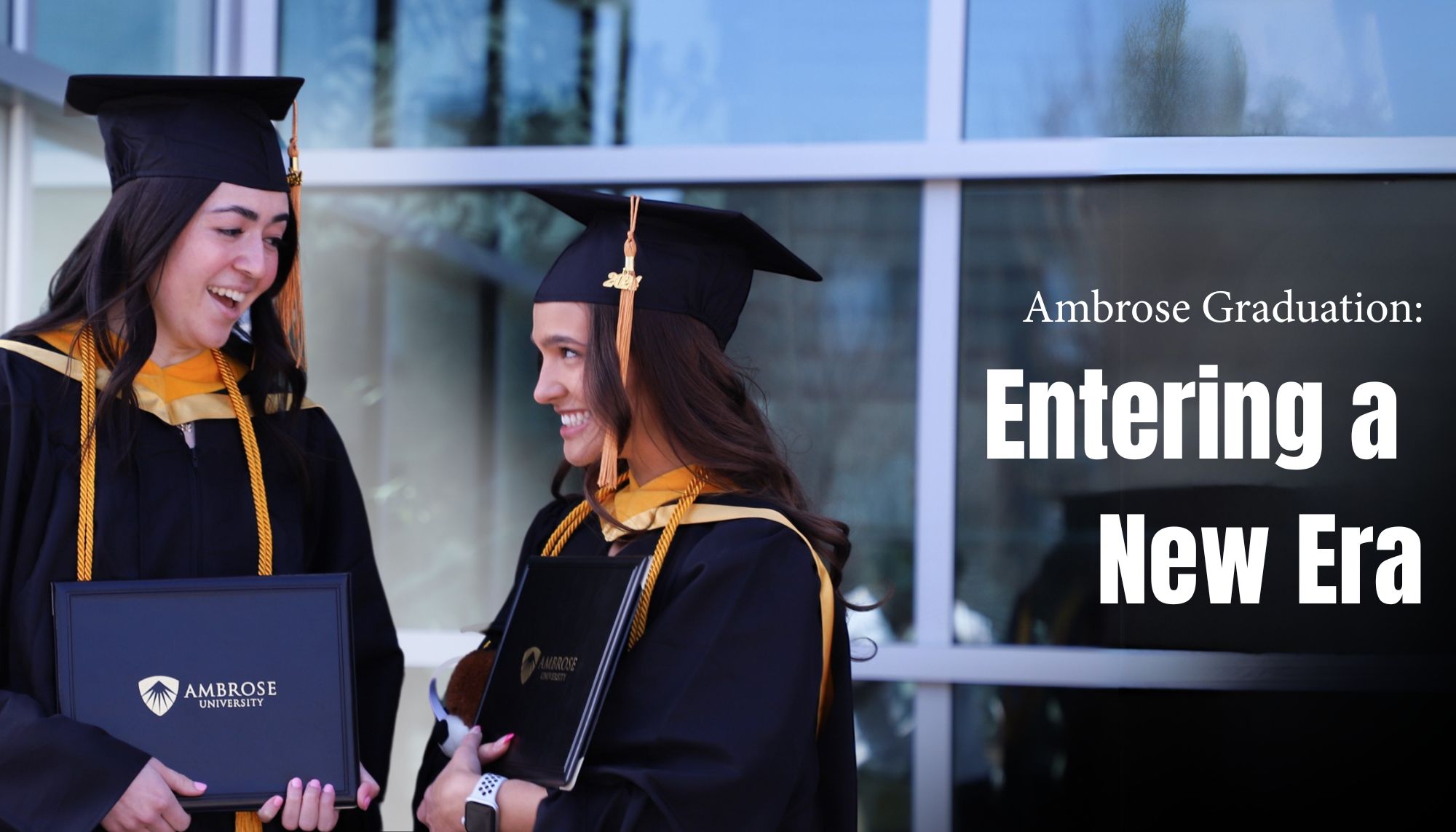 two women graduating and smiling